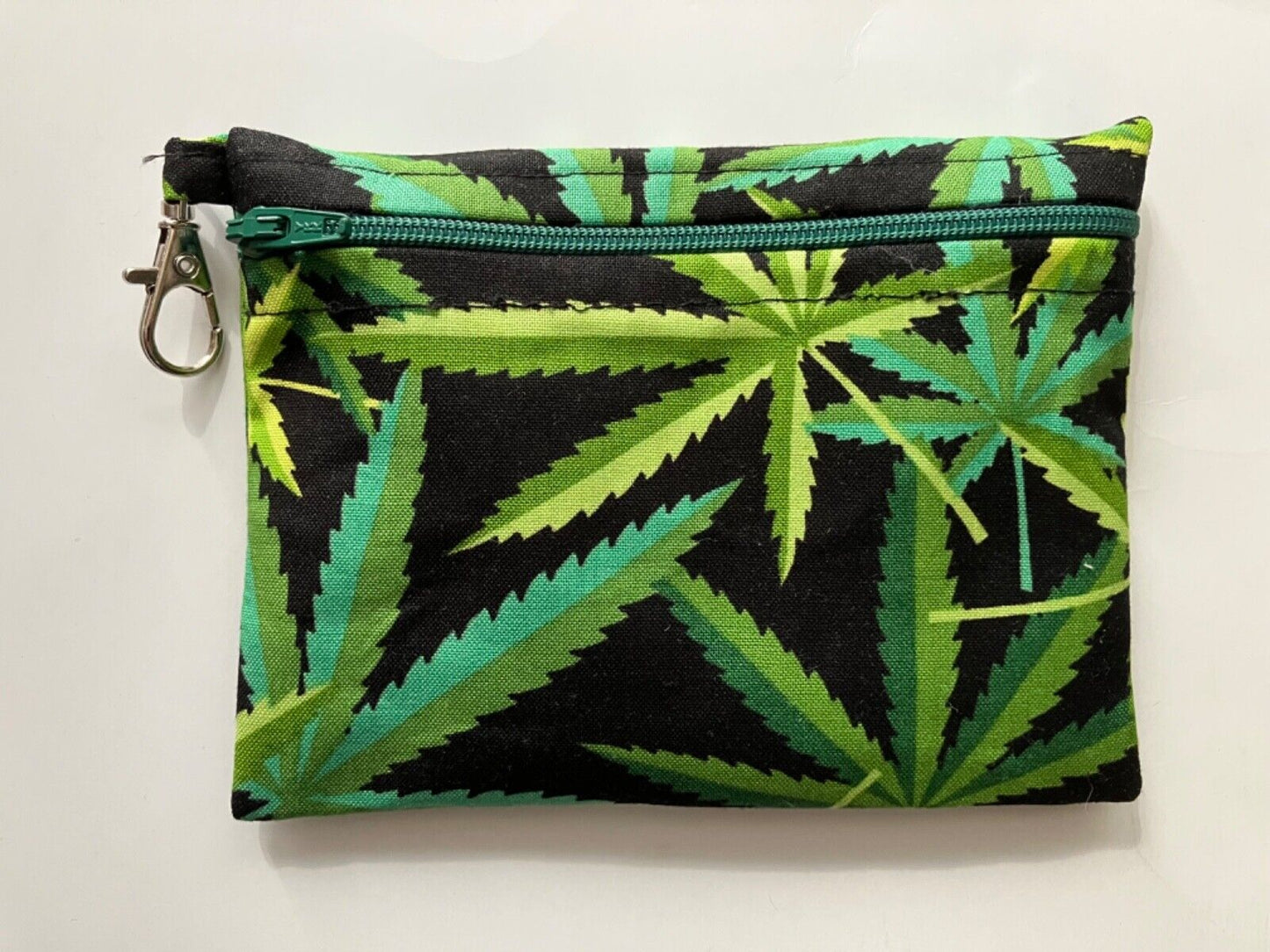 Colorful handmade marijuana small zippered bag, black cotton exterior with marijuana design, ideal for essentials.