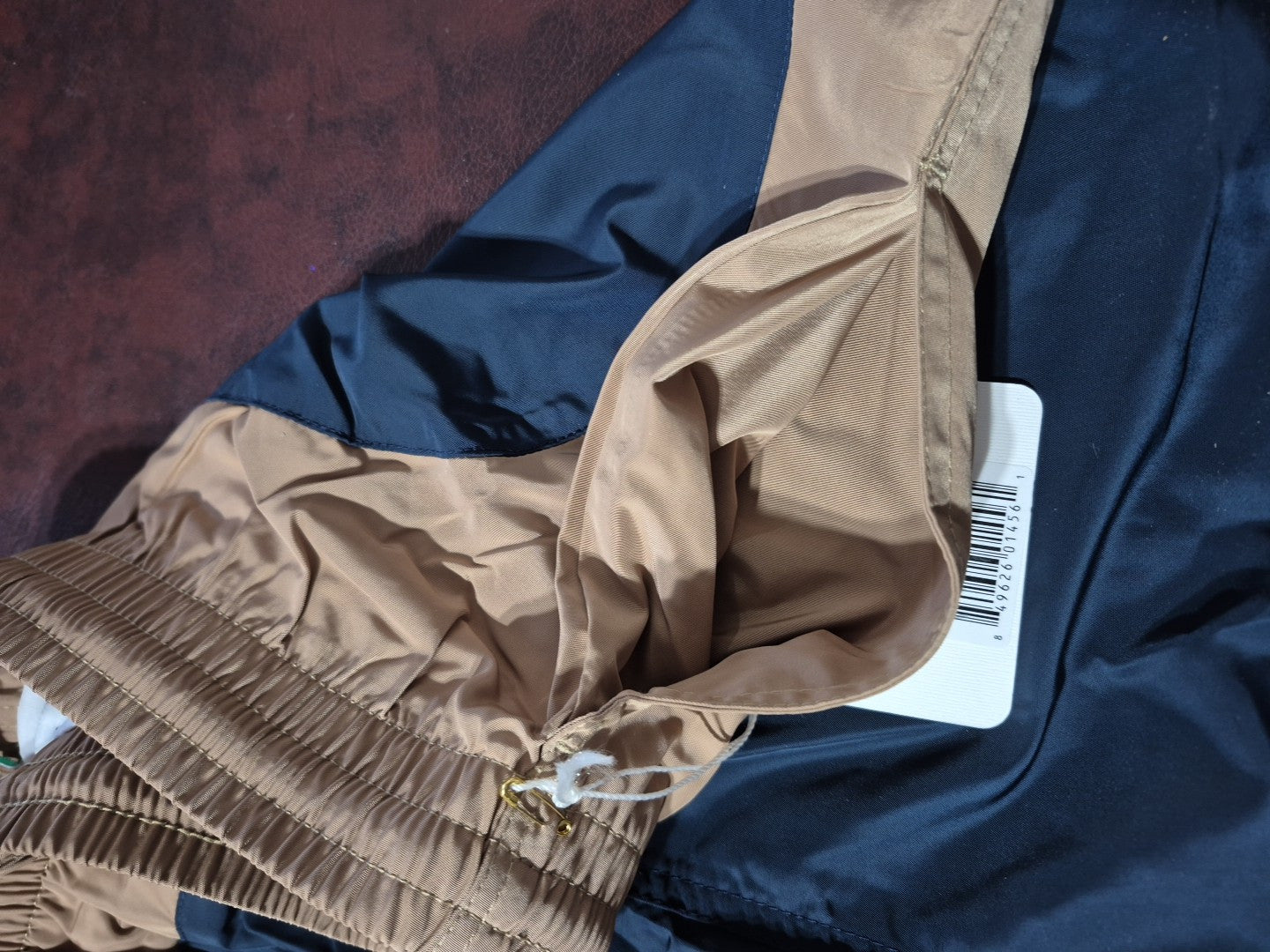 BOAST men's tennis swim trunks in camel and navy with a pot leaf design, featuring a stretch waistband and drawstring.