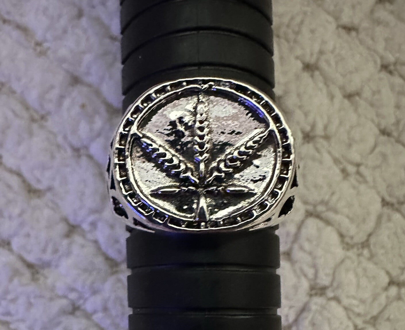 Marijuana leaf ring in shiny silver color made of metal alloy.