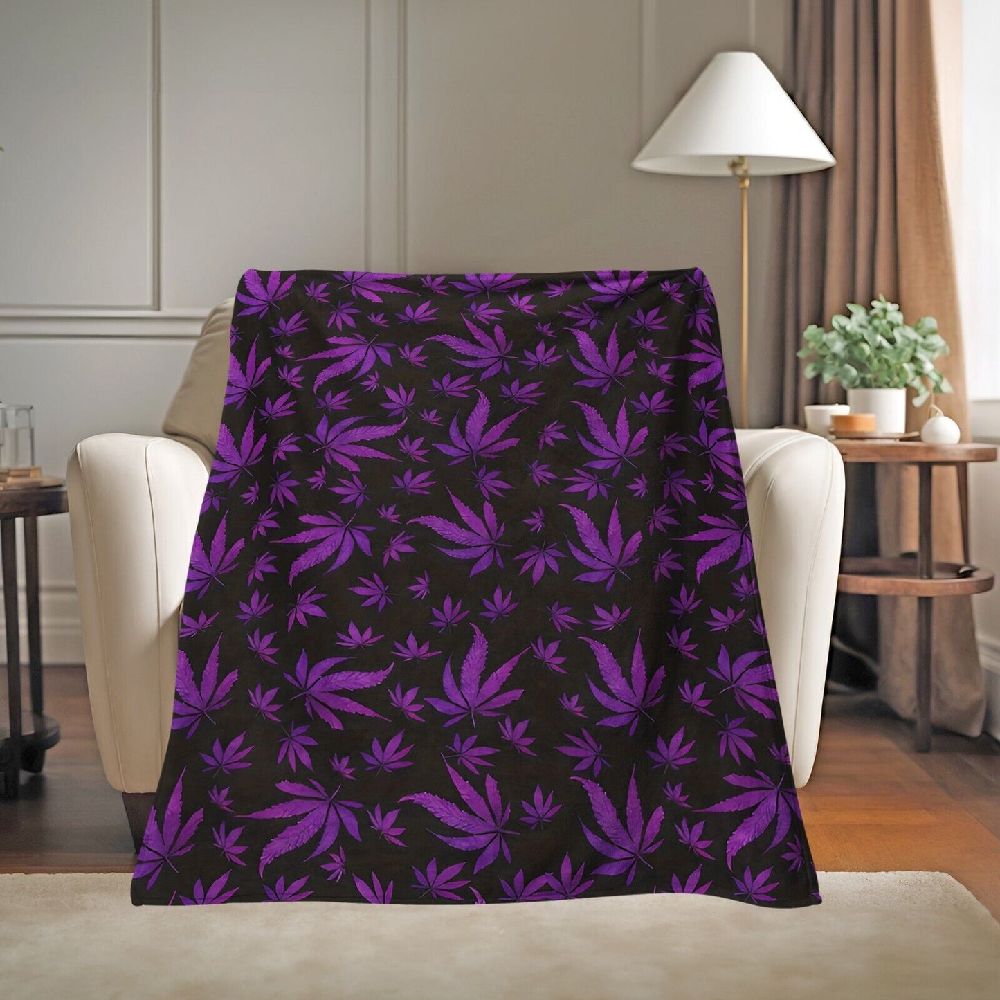 Purple leaf design on microplush fleece throw blanket displayed on a chair in a cozy living room setting.
