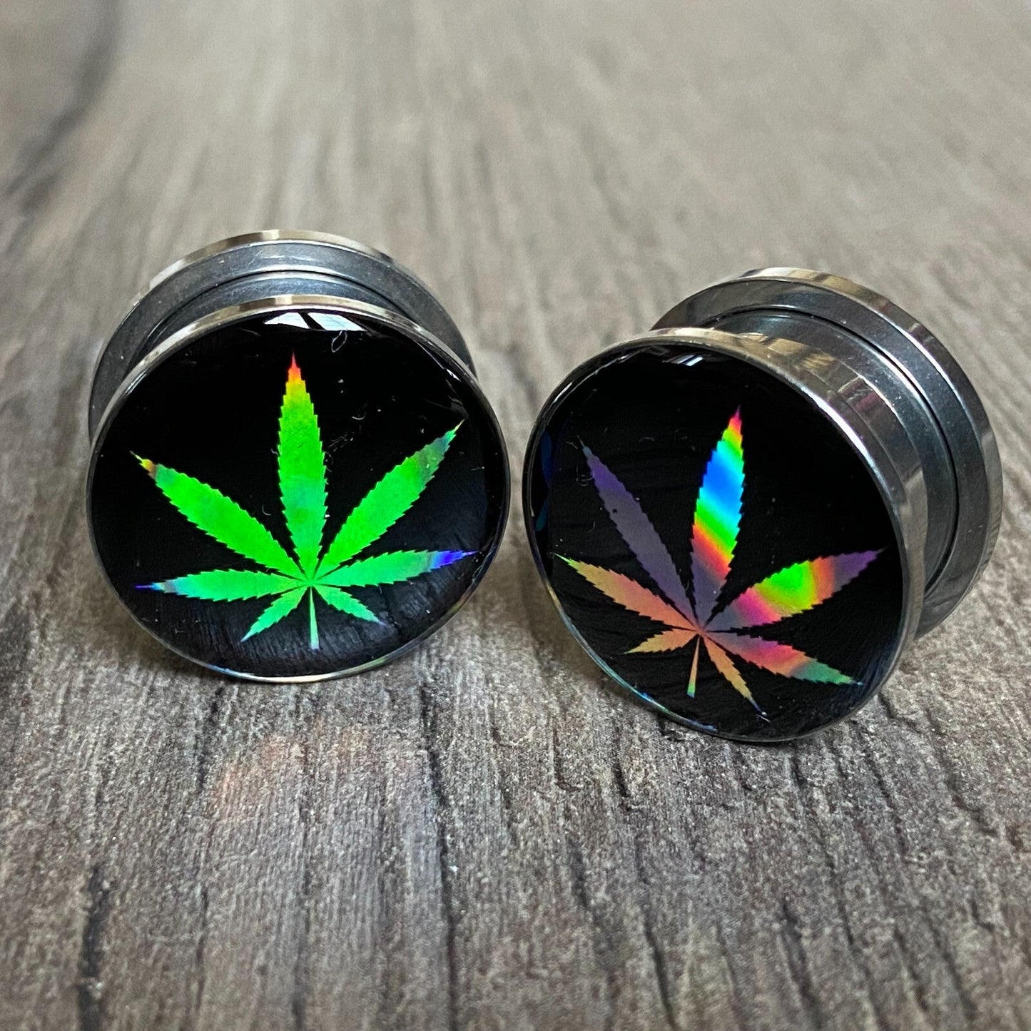 Pair of screw-on holographic pot leaf picture plugs, gauges 16g to 1 inch.