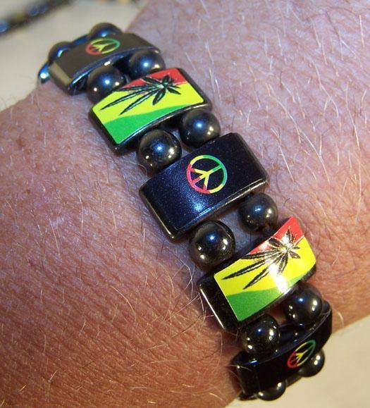 Magnetic hematite bracelet with peace sign and pot leaf designs.
