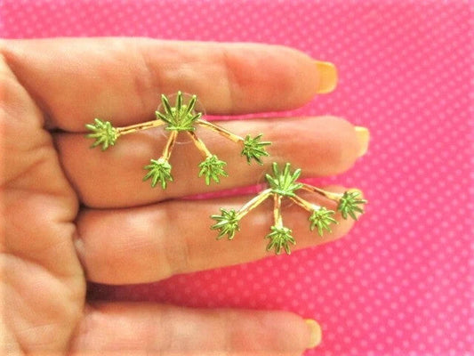 Pot marijuana leaf green ear jackets with 4 detachable leaf jackets on a pink background.
