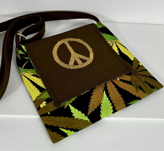 Handmade cannabis crossbody purse with embroidered peace sign.