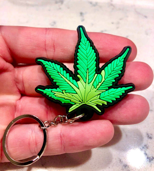 Marijuana pot leaf keychain in bright colors, soft texture.