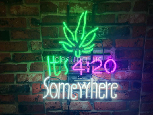 High Life Marijuana 17"x14" neon sign with "It's 4:20 Somewhere" design hanging on a brick wall.