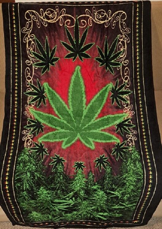 Green red leaf pot design towel with large central marijuana leaf and decorative border.