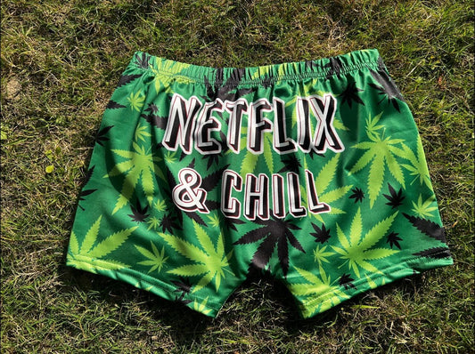 Hemp-themed Chill Weed Yoga Shorts with Netflix & Chill print on grass.