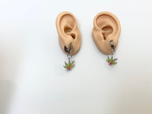 Rasta pot leaf earrings with stainless steel hoops and colorful charms, available as pierced or clip-on.