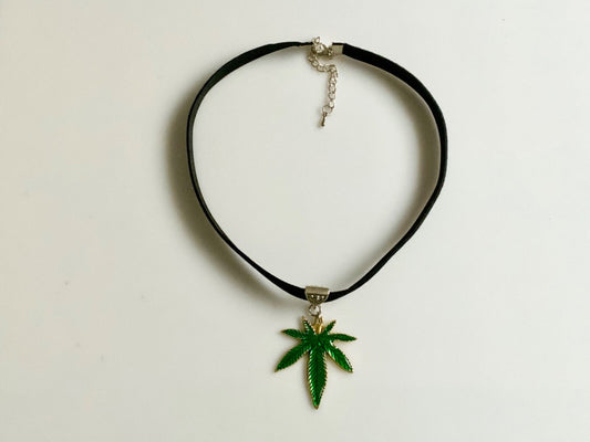 Choker necklace with green marijuana leaf charm on black velvet, custom size.