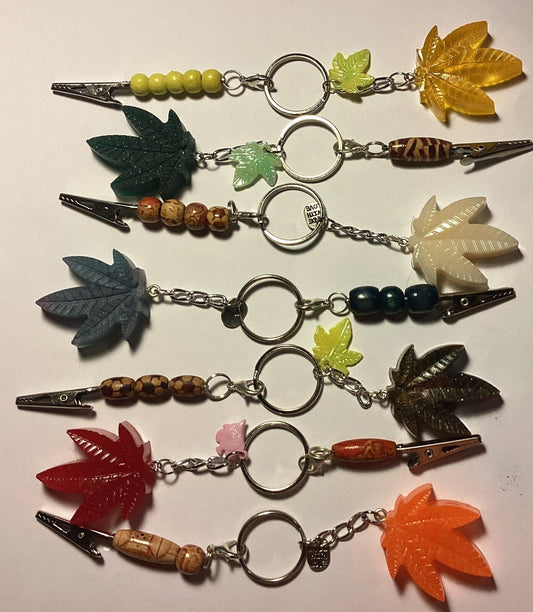 6 ct. Weed Leaf keychains with bonus clip in colorful resin.